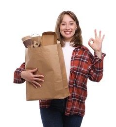 Photo of Recycling. Smiling woman with bag full of different waste paper showing OK gesture on white background
