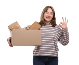 Photo of Recycling. Smiling woman holding cardboard box with different waste paper and showing Ok gesture on white background