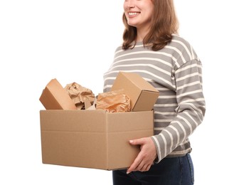 Photo of Recycling. Woman holding cardboard box with different waste paper on white background, closeup