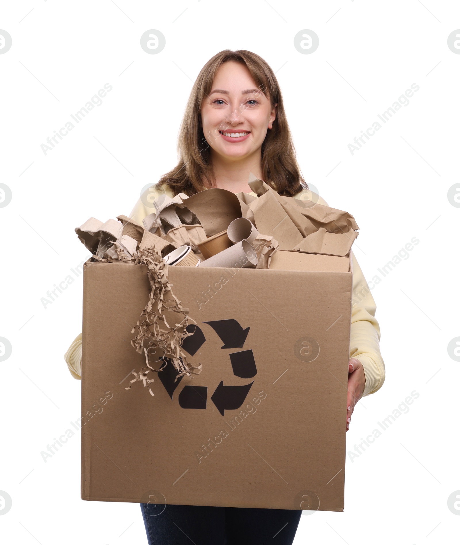 Photo of Recycling. Smiling woman holding cardboard box with different waste paper on white background