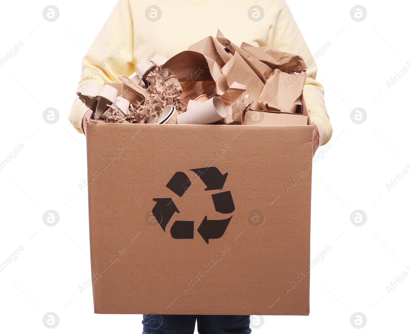 Photo of Recycling. Woman holding cardboard box with different waste paper on white background, closeup