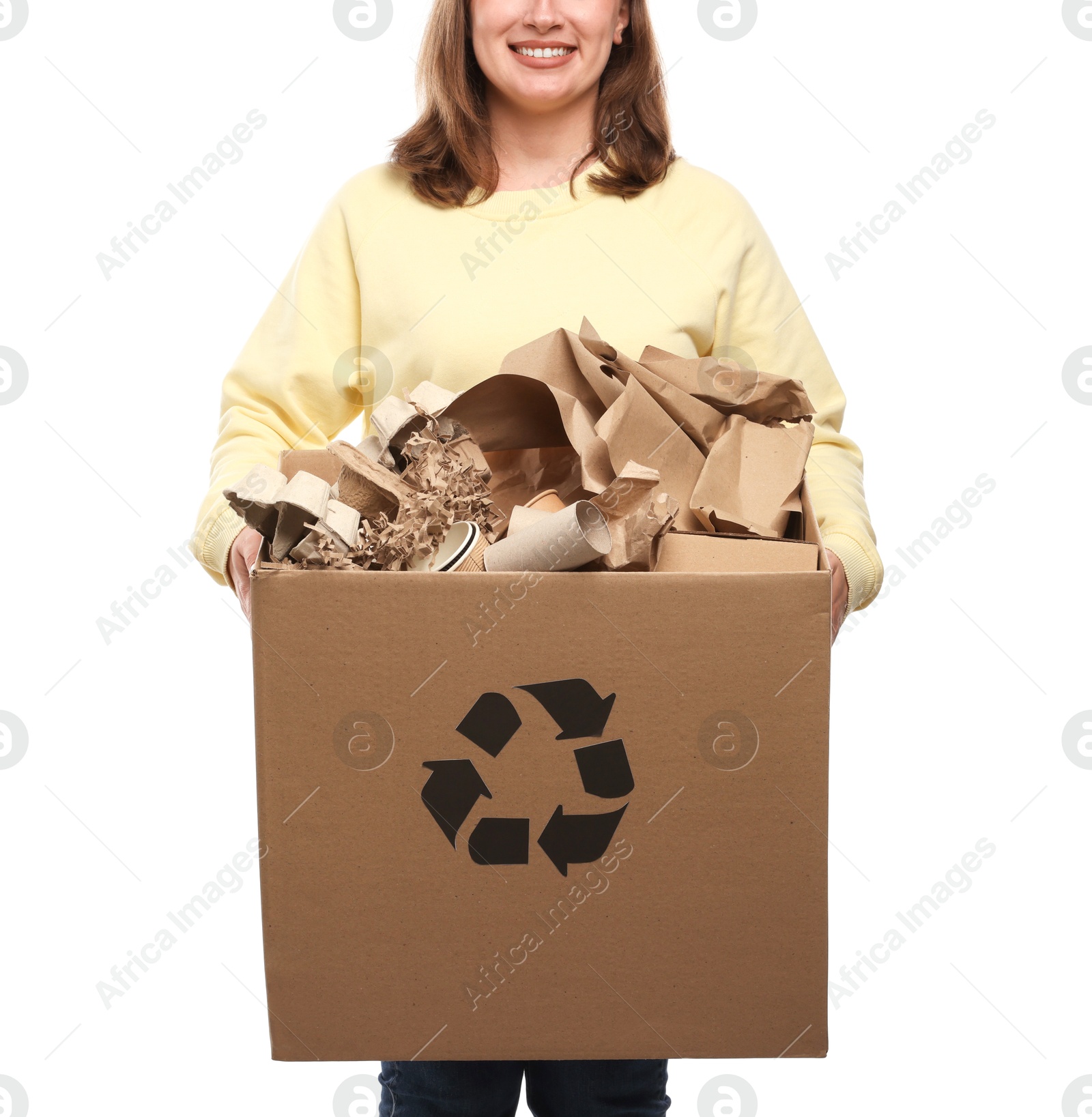 Photo of Recycling. Woman holding cardboard box with different waste paper on white background, closeup