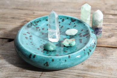 Photo of Many different healing stones on wooden table, closeup