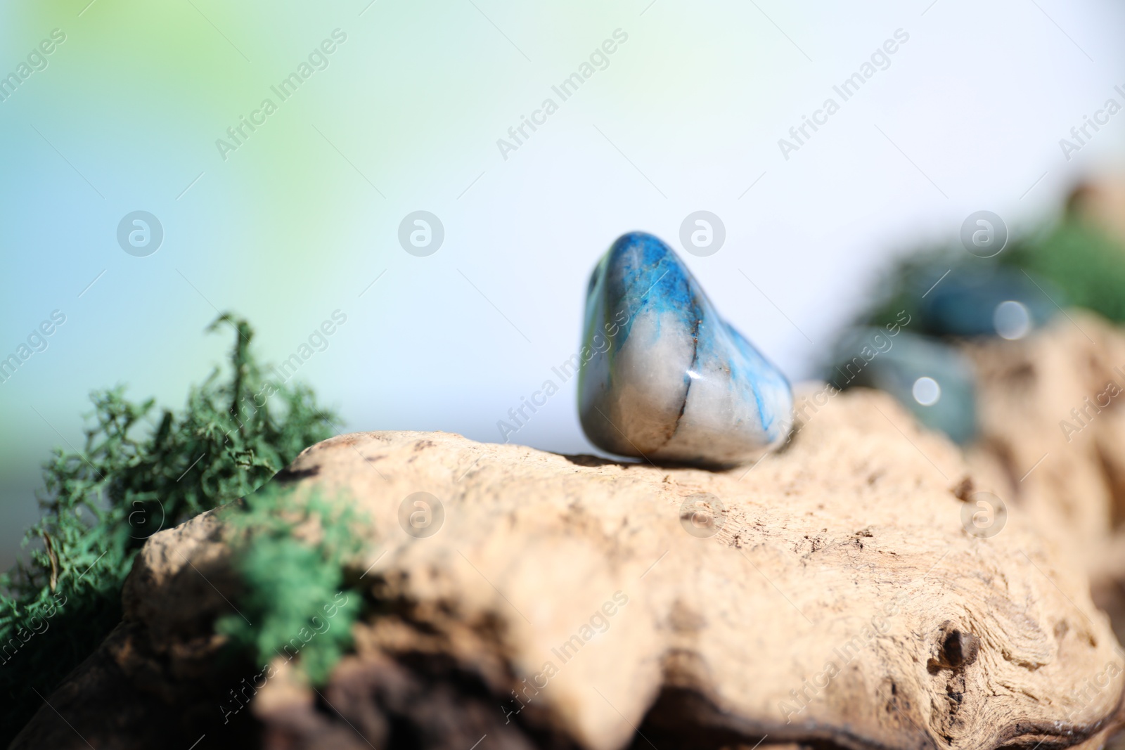 Photo of Healing stones and green moss on wood, closeup. Space for text