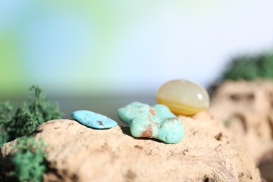 Photo of Healing stones and green moss on wood, closeup. Space for text