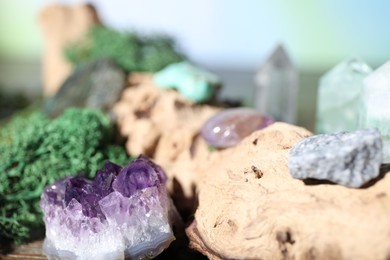 Photo of Healing stones and green moss on wood, closeup