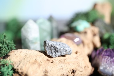 Photo of Healing stones and green moss on wood, closeup