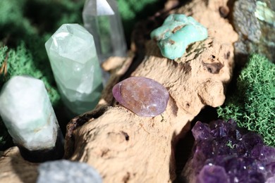 Photo of Healing stones and green moss on wood, closeup