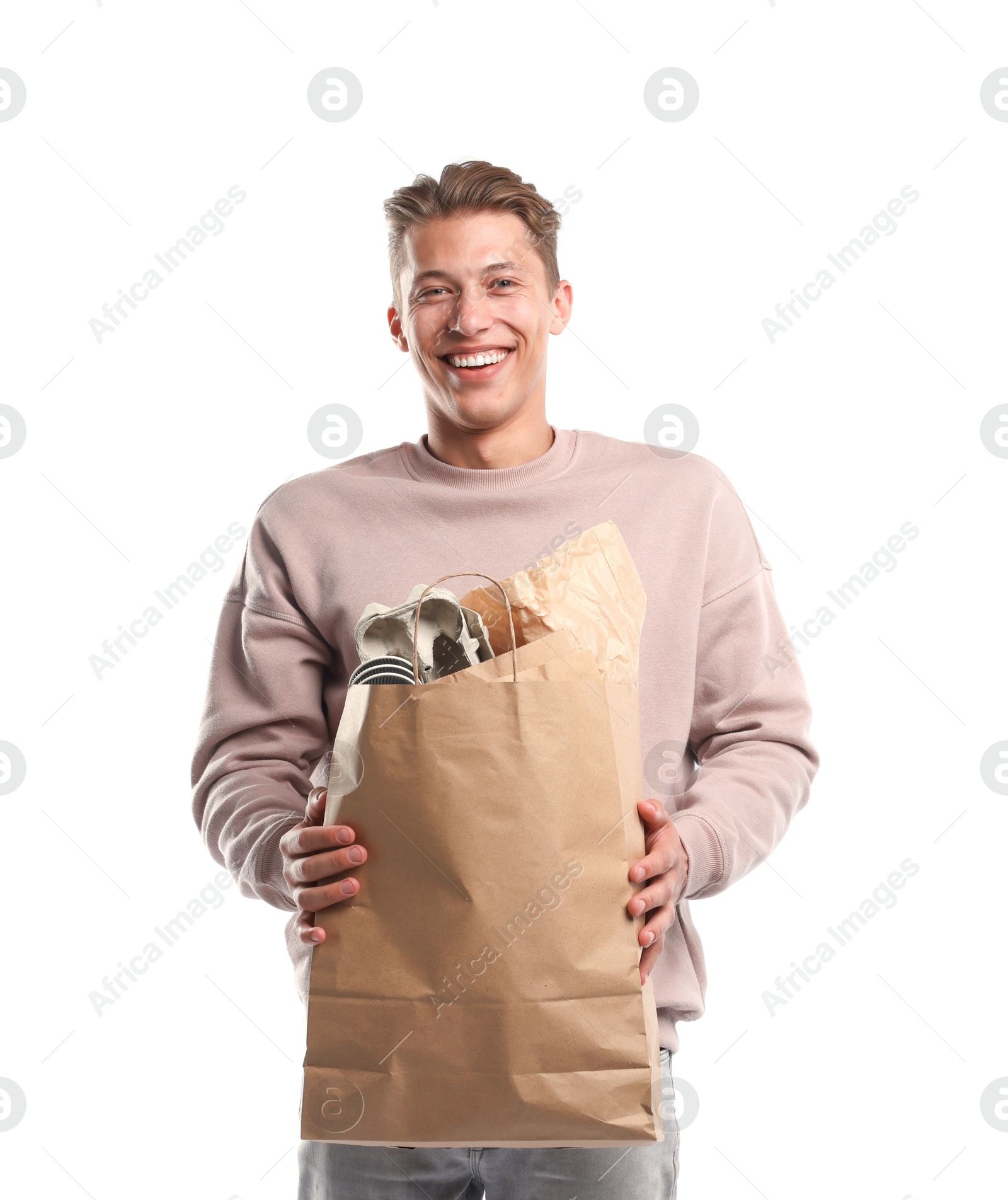 Recycling. Smiling man with bag full of different waste paper on white background Photo of Recycling. Smiling man with bag full of different waste paper on white background