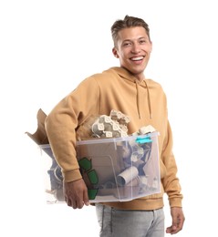 Photo of Recycling. Smiling man holding plastic box with different waste paper on white background