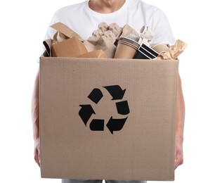 Photo of Recycling. Man holding cardboard box with different waste paper on white background, closeup
