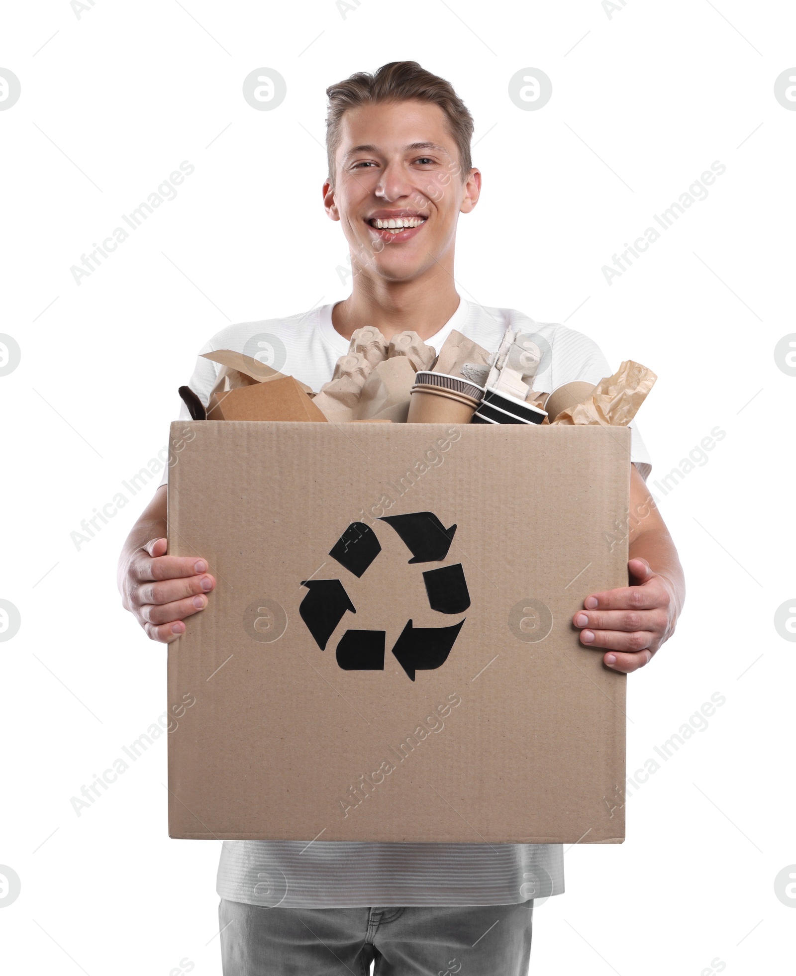 Recycling. Smiling man holding cardboard box with different waste paper on white background Photo of Recycling. Smiling man holding cardboard box with different waste paper on white background