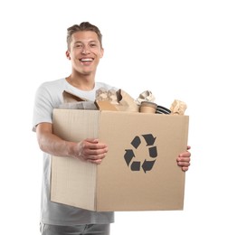 Photo of Recycling. Smiling man holding cardboard box with different waste paper on white background