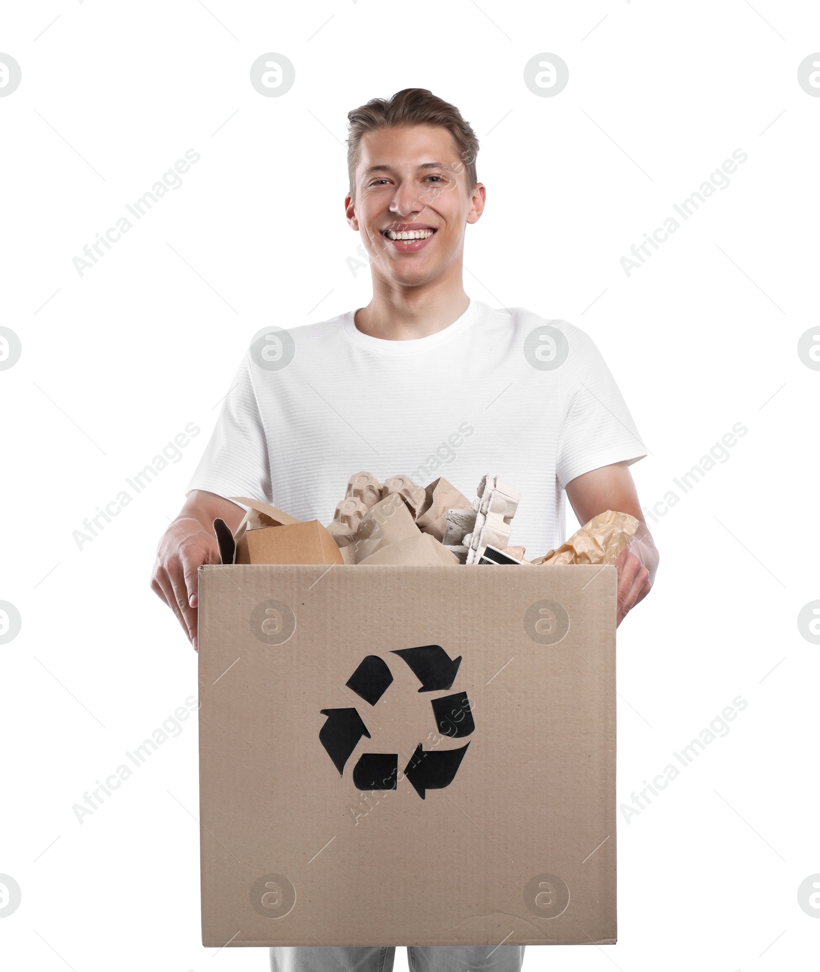 Recycling. Smiling man holding cardboard box with different waste paper on white background Photo of Recycling. Smiling man holding cardboard box with different waste paper on white background