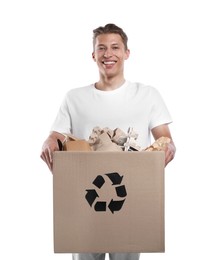 Photo of Recycling. Smiling man holding cardboard box with different waste paper on white background