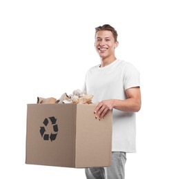 Photo of Recycling. Smiling man holding cardboard box with different waste paper on white background