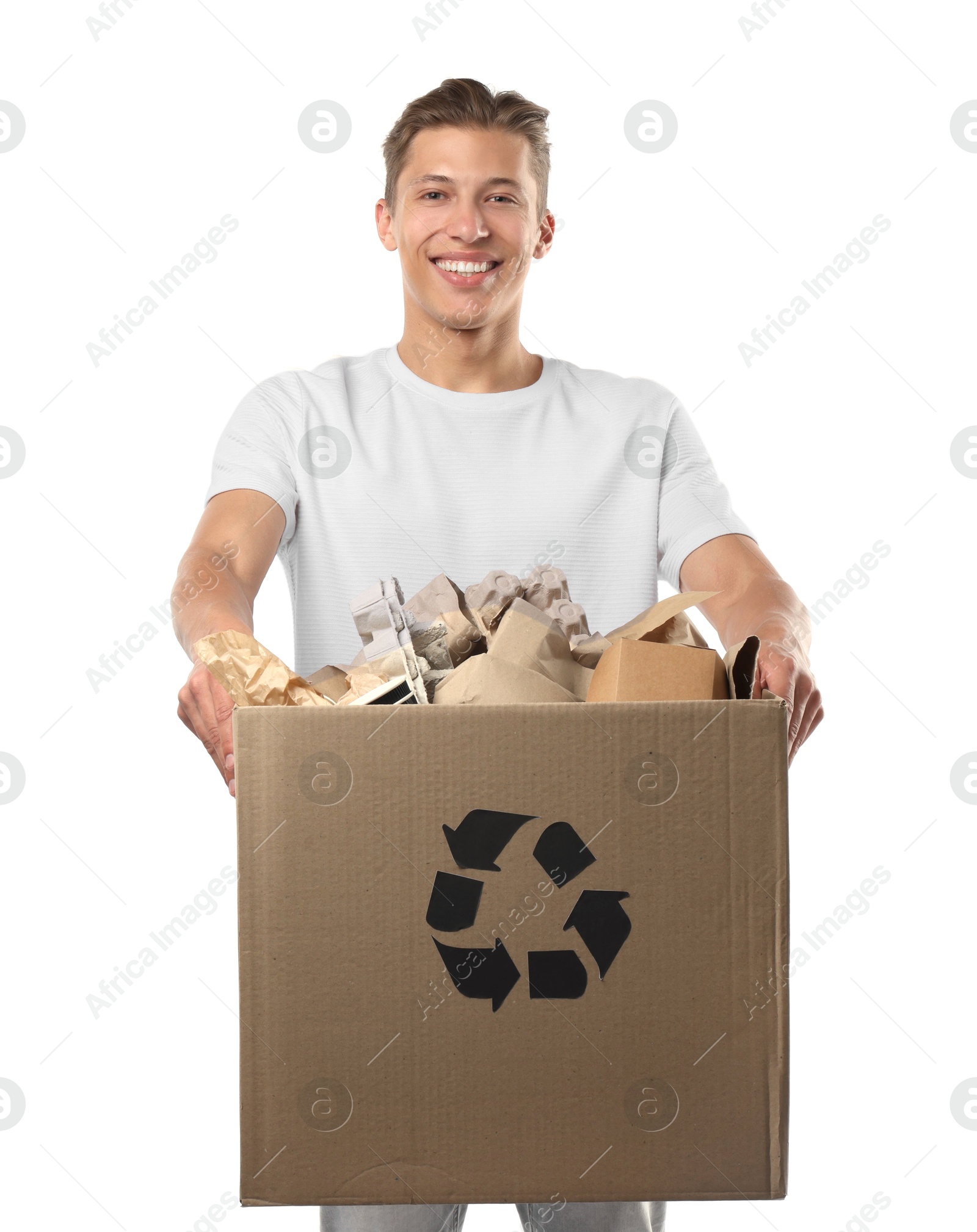 Recycling. Smiling man holding cardboard box with different waste paper on white background Photo of Recycling. Smiling man holding cardboard box with different waste paper on white background