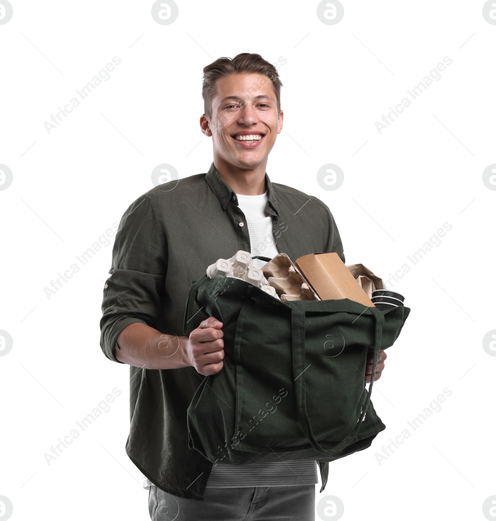 Recycling. Smiling man with bag full of different waste paper on white background Photo of Recycling. Smiling man with bag full of different waste paper on white background