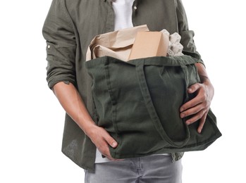 Photo of Recycling. Man with bag full of different waste paper on white background, closeup