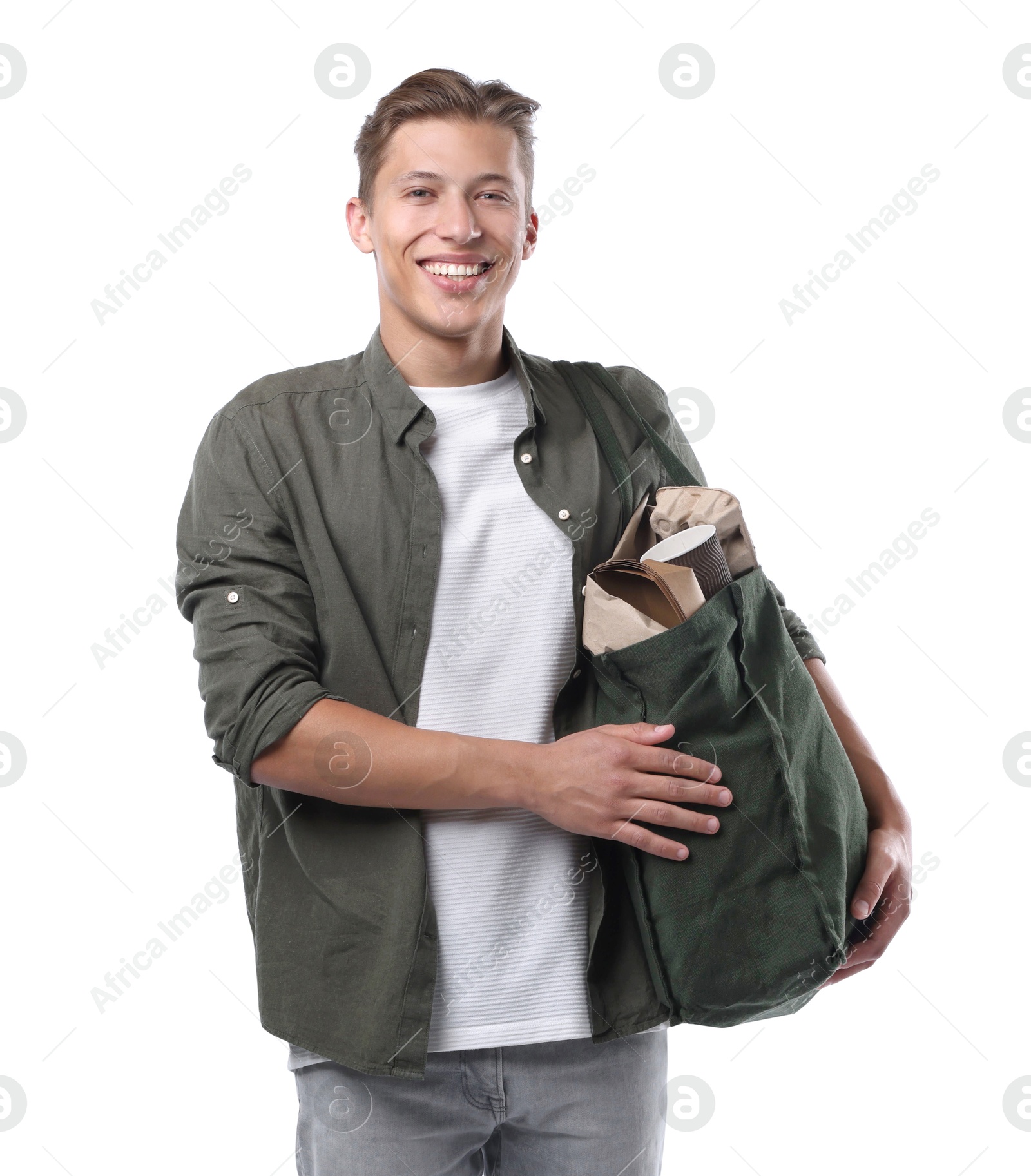 Recycling. Smiling man with bag full of different waste paper on white background Photo of Recycling. Smiling man with bag full of different waste paper on white background