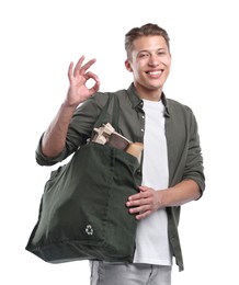 Photo of Recycling. Smiling man with bag full of different waste paper showing OK gesture on white background