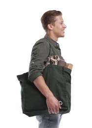 Photo of Recycling. Smiling man with bag full of different waste paper on white background