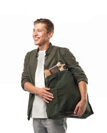 Photo of Recycling. Smiling man with bag full of different waste paper on white background