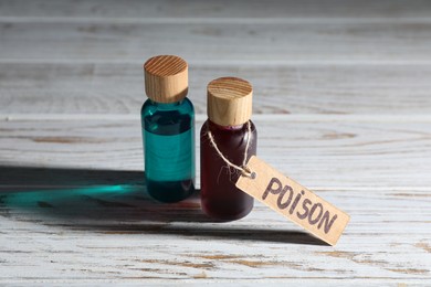 Photo of Bottles of poisons on wooden table, closeup