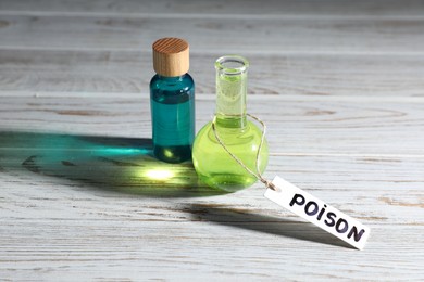 Photo of Bottles of poisons on wooden table, closeup