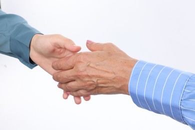 Photo of Women shaking hands on white background, closeup