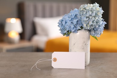 Photo of Welcome. Blank card and hydrangea flowers on grey table indoors, space for text