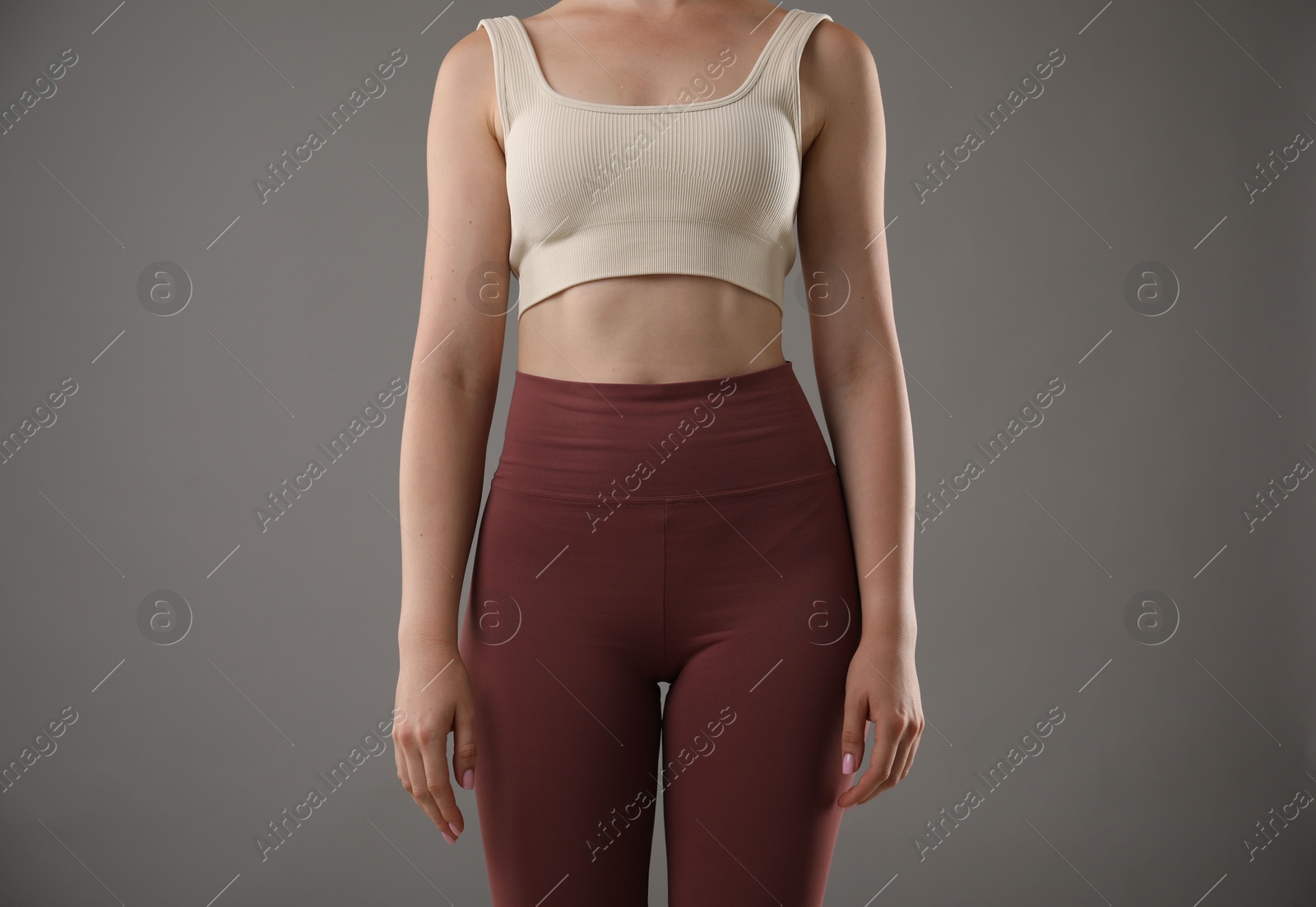 Woman with good posture on grey background, closeup Photo of Woman with good posture on grey background, closeup