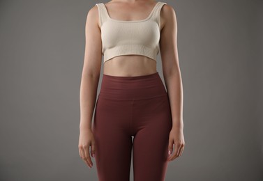 Photo of Woman with good posture on grey background, closeup