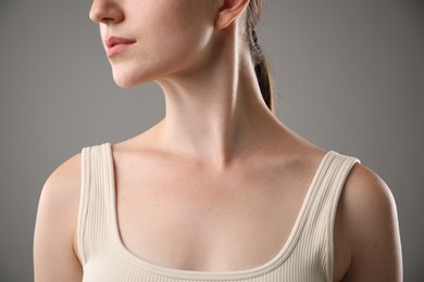 Photo of Closeup view of woman on grey background