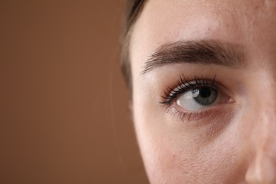 Photo of Woman before cosmetic procedure on brown background, closeup. Space for text