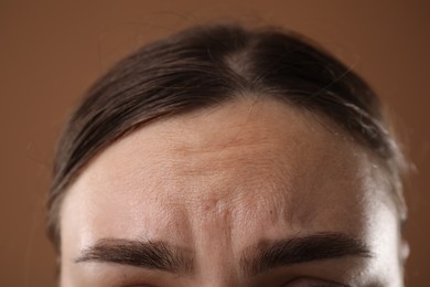 Photo of Woman before rejuvenation on brown background, closeup