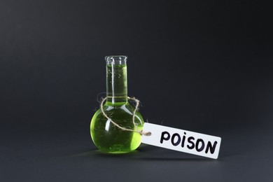 Photo of One flask with poison on black background