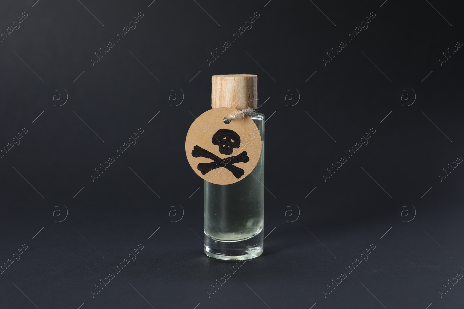 One bottle of poison with warning sign on black background Photo of One bottle of poison with warning sign on black background