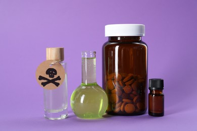 Photo of Bottles of poisons with warning sign on violet background