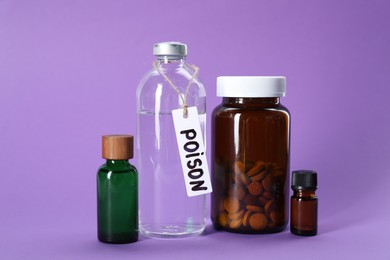 Photo of Glass bottles with poisons on violet background