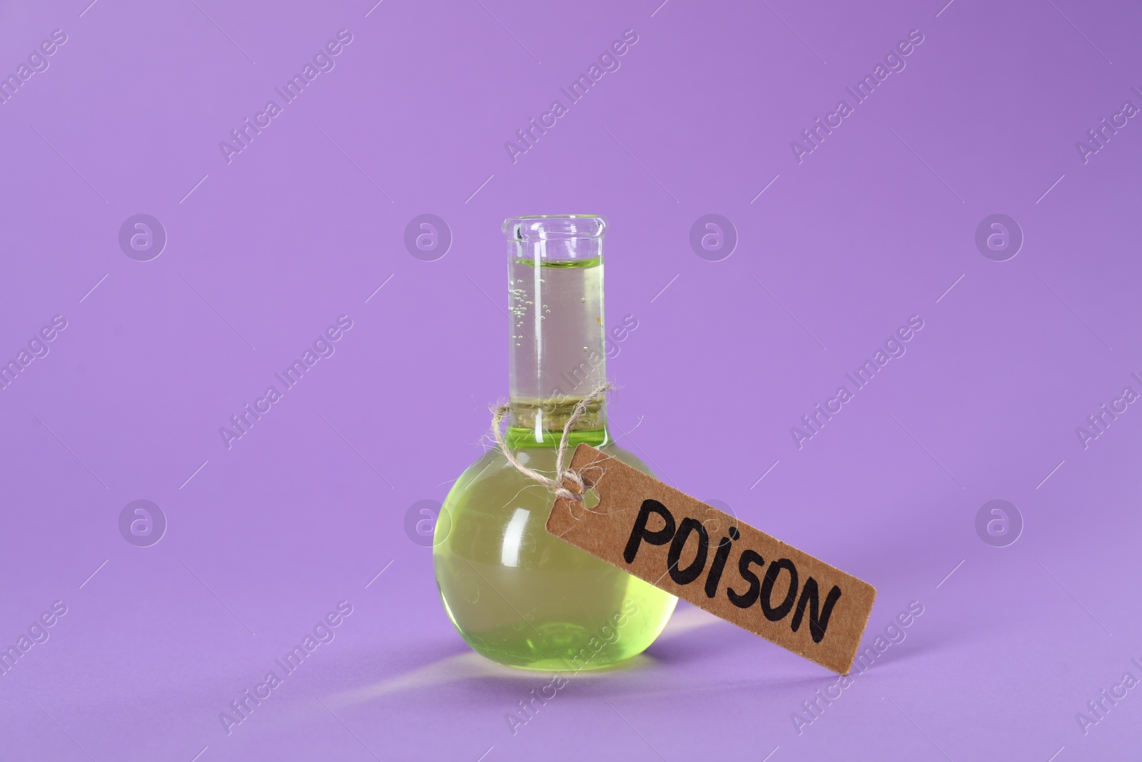 Glass flask with poison on violet background, closeup Photo of Glass flask with poison on violet background, closeup