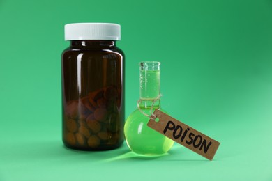 Photo of Bottles with poisons on green background, closeup