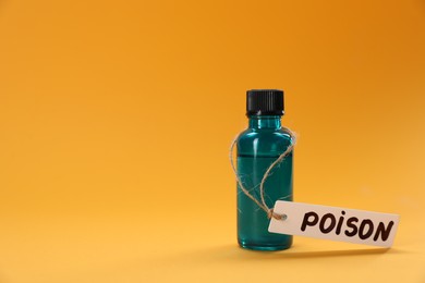 Photo of Bottle of poison on orange background, space for text
