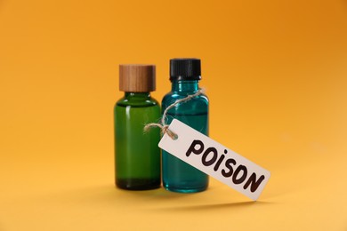 Photo of Bottles of poisons on orange background, closeup