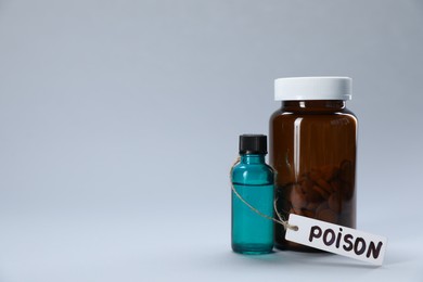 Photo of Bottles of poisons on light grey background, space for text