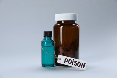 Photo of Bottles of poisons on light grey background