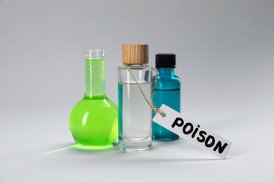 Photo of Bottles of poisons on light grey background