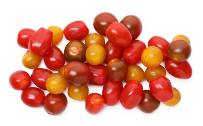 Photo of Heap of different ripe juicy tomatoes isolated on white, top view