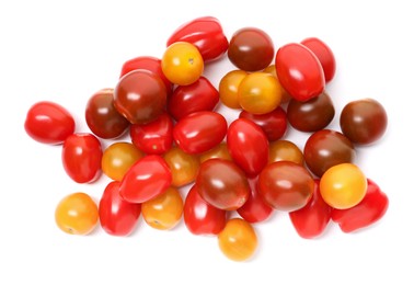 Photo of Heap of different ripe juicy tomatoes isolated on white, top view