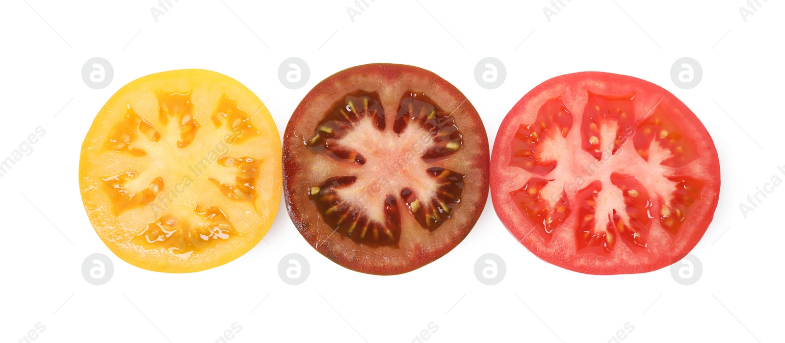 Pieces of different ripe juicy tomatoes isolated on white, top view Photo of Pieces of different ripe juicy tomatoes isolated on white, top view